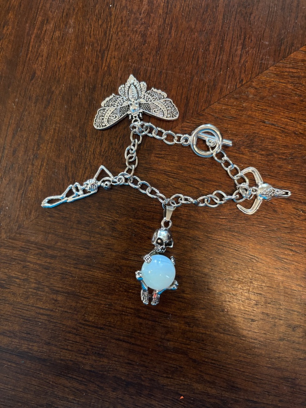 Silver Tone Charm Bracelet with Opalescent Globe and Skull Charm